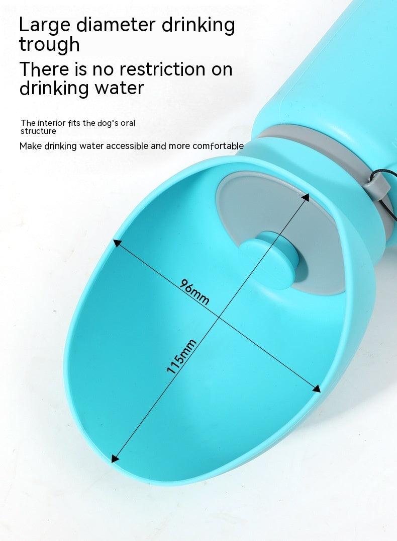 Folding pet water bottle in use during outdoor walk - Blue