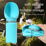 Folding pet water bottle in use during outdoor walk - Blue